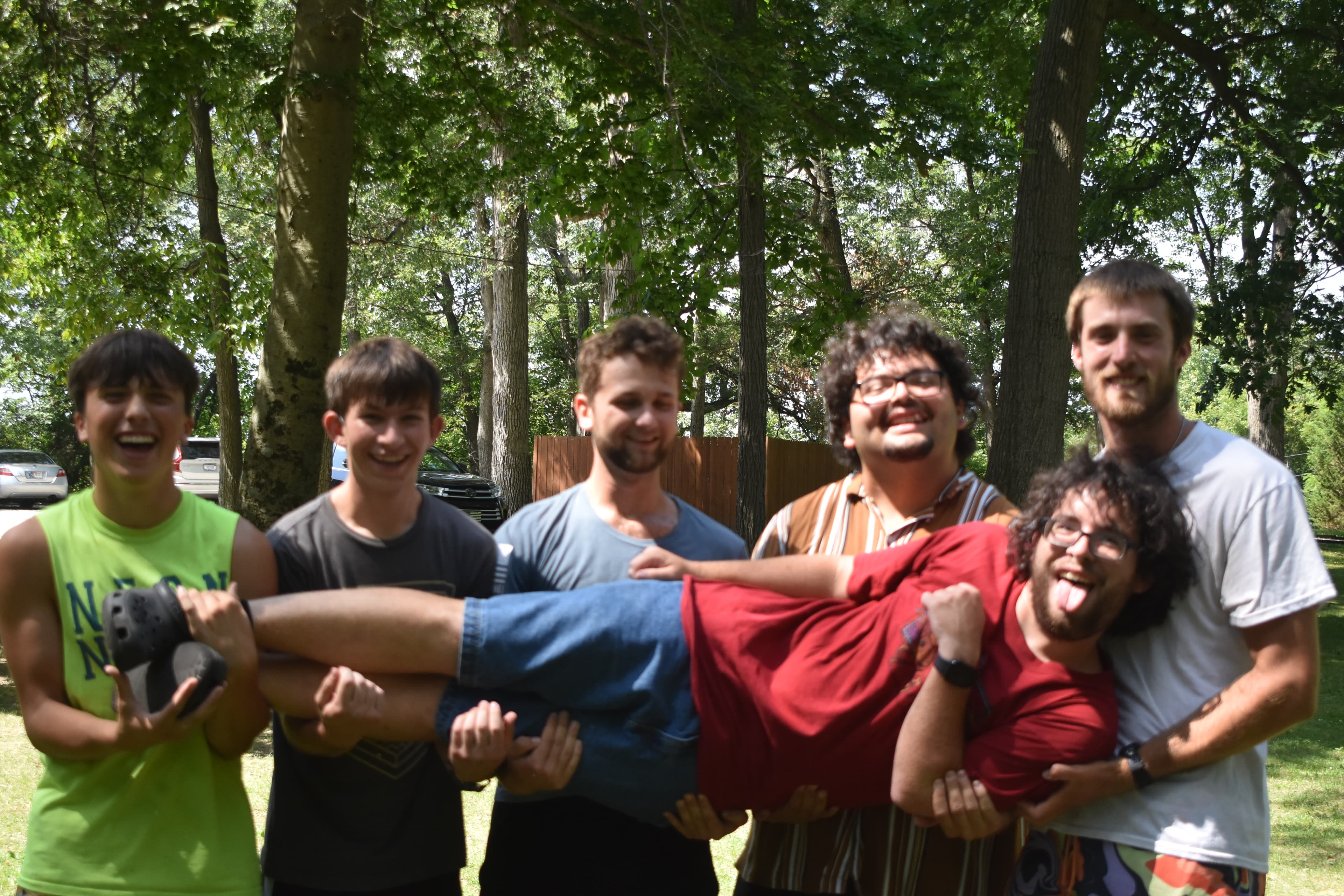 Cabin counselor with campers around a campfire