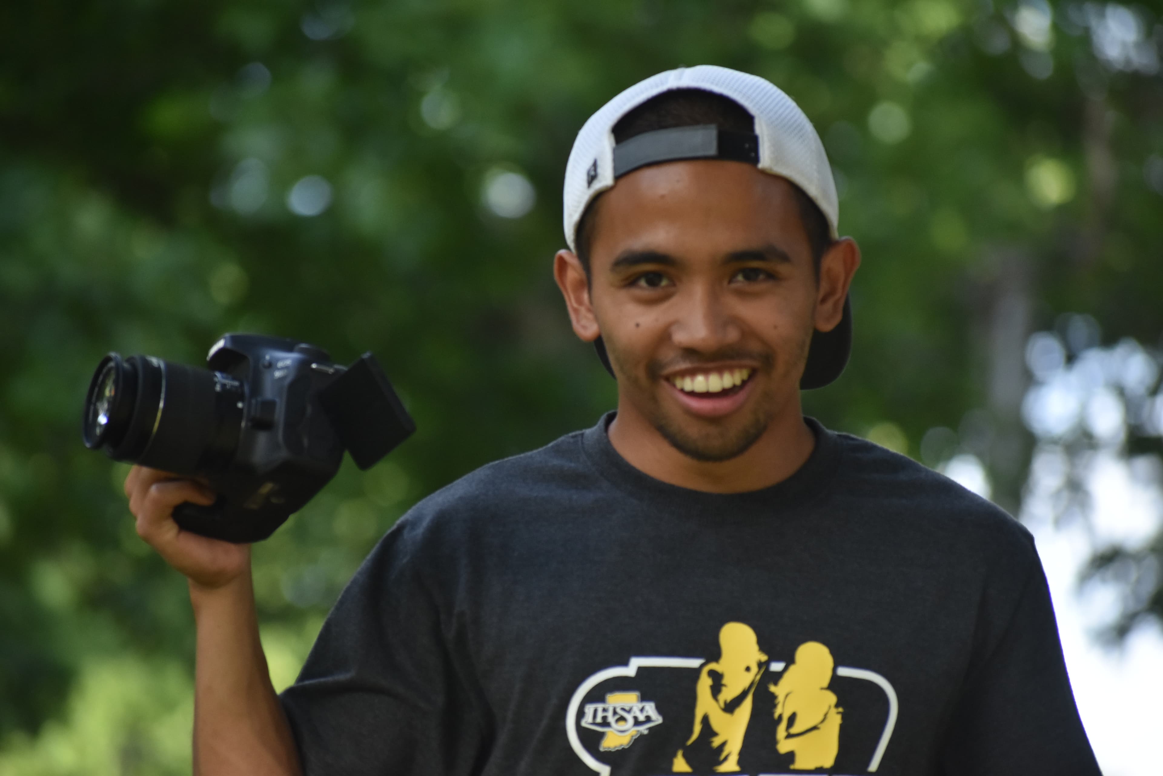 Media team member filming camp activities